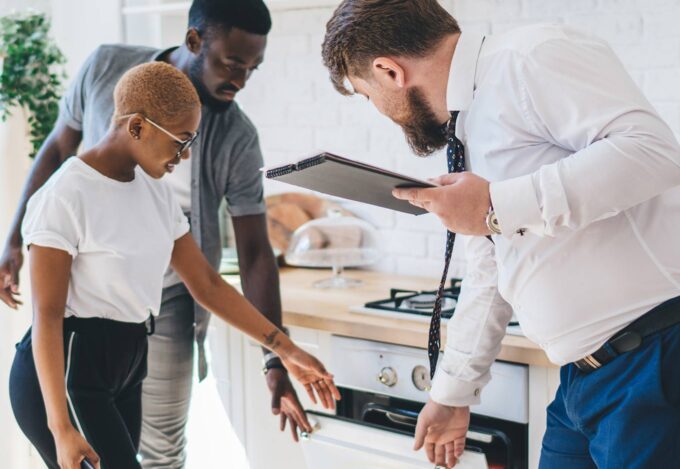 Realtor and potential homebuyers viewing a house